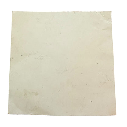Back of sticker showing dirt and marks on a white background
