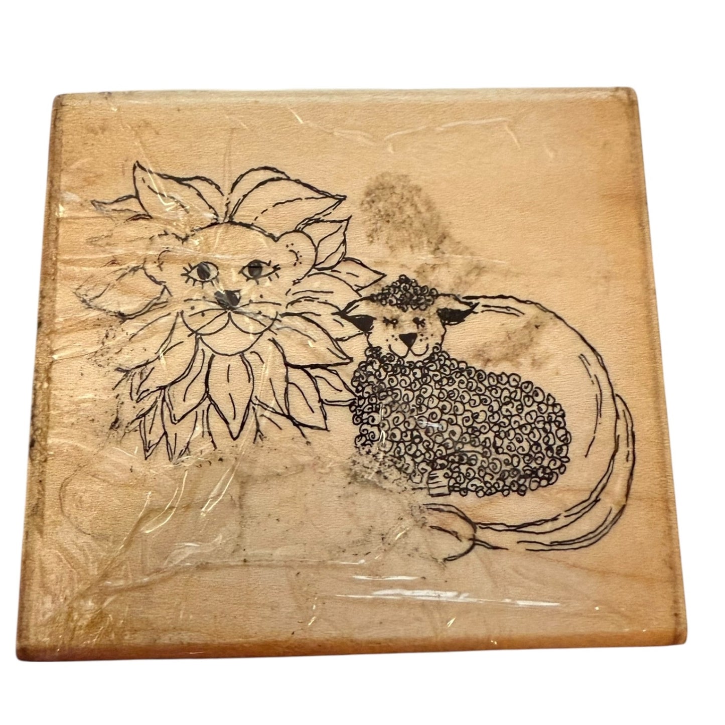 Wooden block with engraved design of a lion and lamb rubber stamp