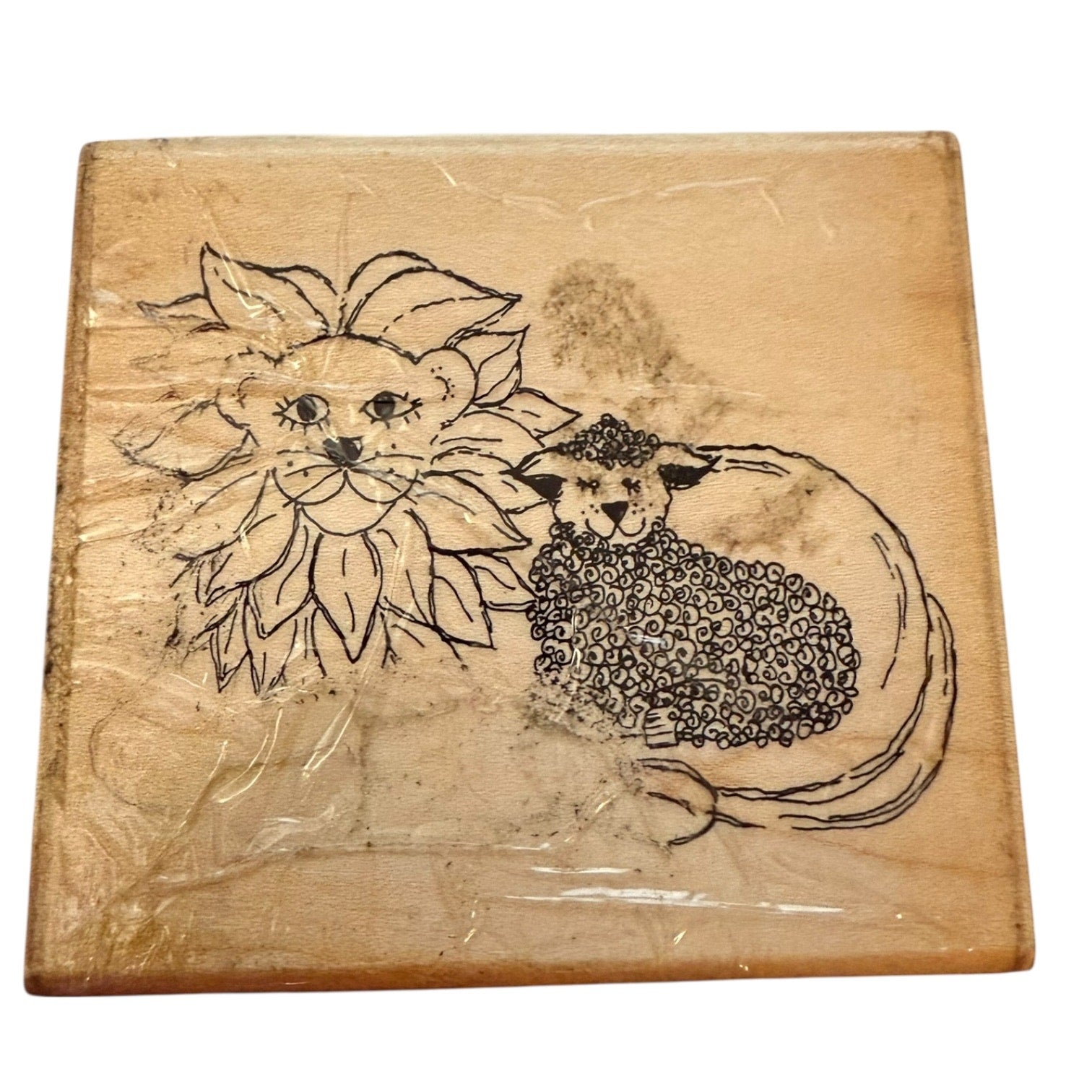 Wooden block with engraved design of a lion and lamb rubber stamp