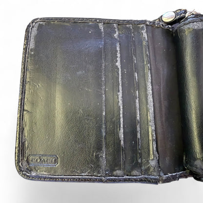 Interior of leather wallet with visible wear and tear on a white background
