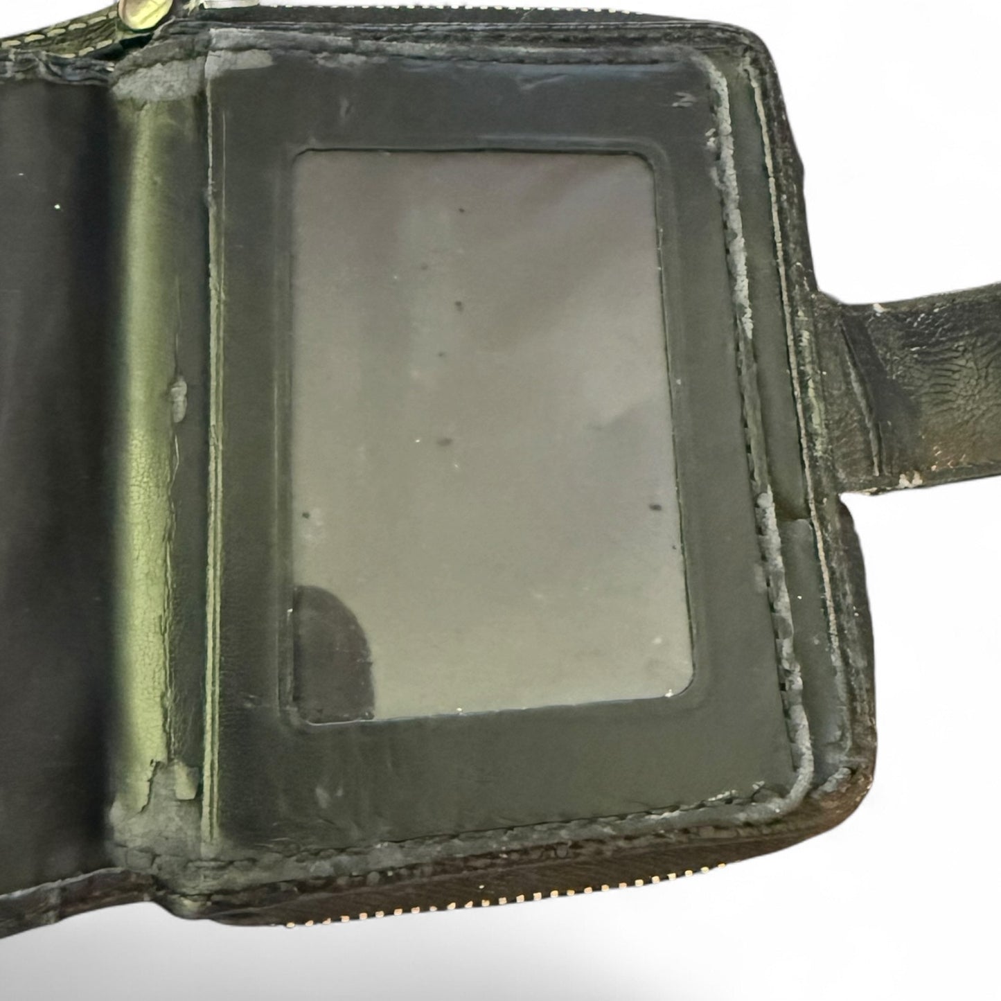 Worn leather wallet with a reflective surface on a white background