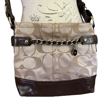 Beige handbag with brown accents and a chain detail on a white background