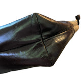 Close-up of a brown leather purse corner on a white background