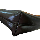 Close-up of a corner of brown leather purse with a white background