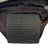 Coach bag label on a dark brown leather bag