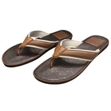 Front side of Pair of brown and white flip-flops on a white background