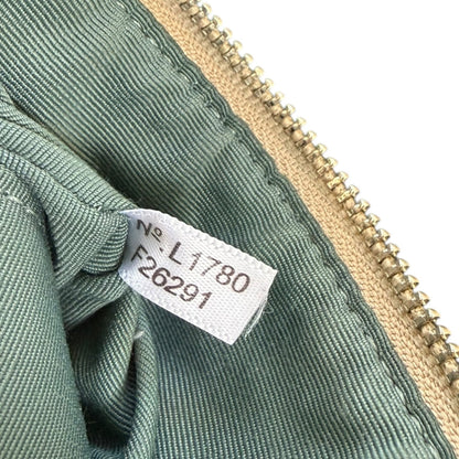 Green fabric with a zipper and a label on a white background
