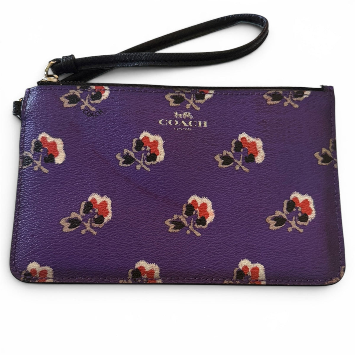 Purple Coach wristlet with floral pattern on a white background