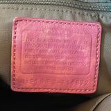 Purple leather label on a bag with text and numbers.