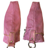 Sides of purple Coach CC purse with metal clips on a white background