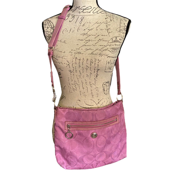 Purple crossbody bag on a mannequin with a script background
