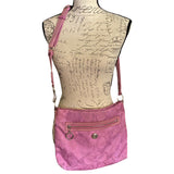 Purple crossbody bag on a mannequin with a script background