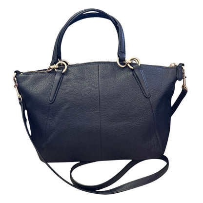 A black pebbled leather handbag with gold-tone hardware, featuring dual top handles and a detachable shoulder strap, shown against a plain white background.