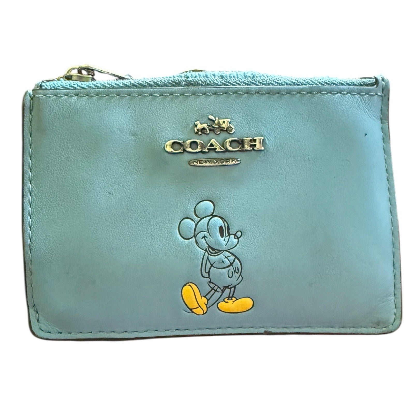 Light blue Coach wallet with cartoon character on a white background