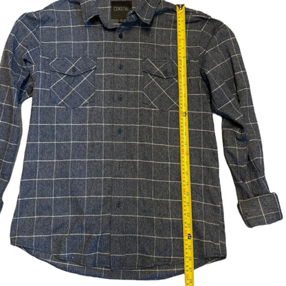 A blue plaid button-up shirt with a yellow measuring tape running vertically along the side to show the garment's length. 