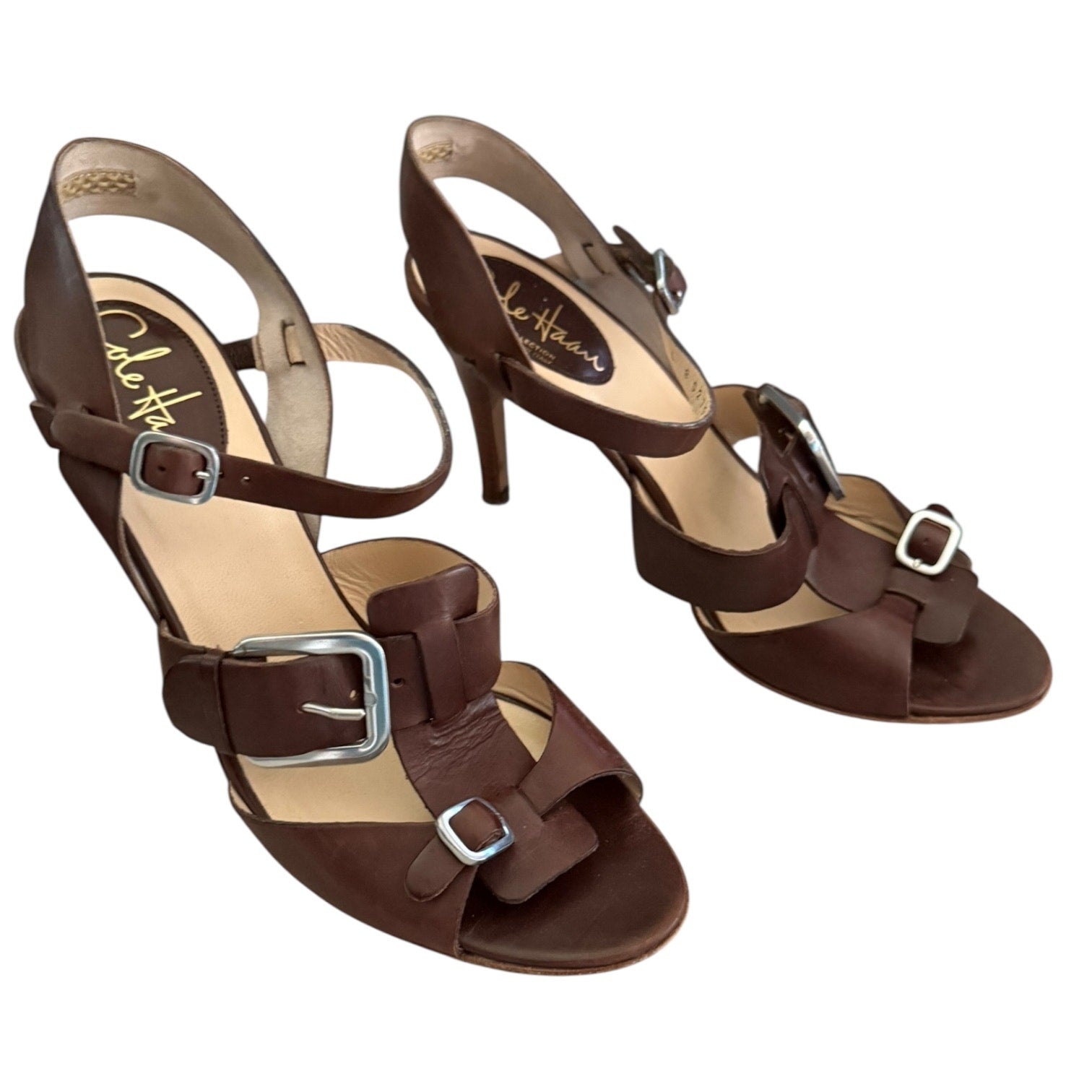 Pair of brown sandals with buckles on a white background front side