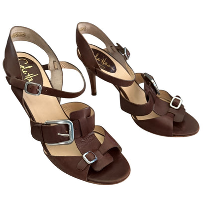 Pair of brown sandals with buckles on a white background front side