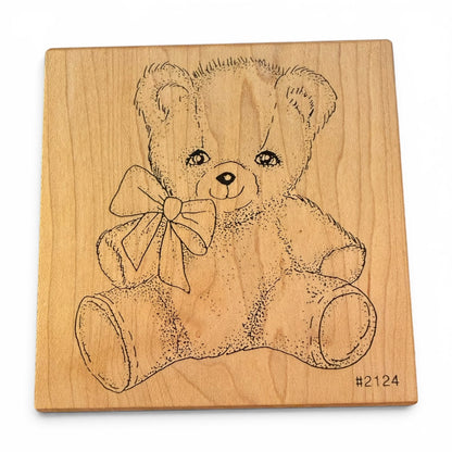 Wooden block with a teddy bear design on a white background