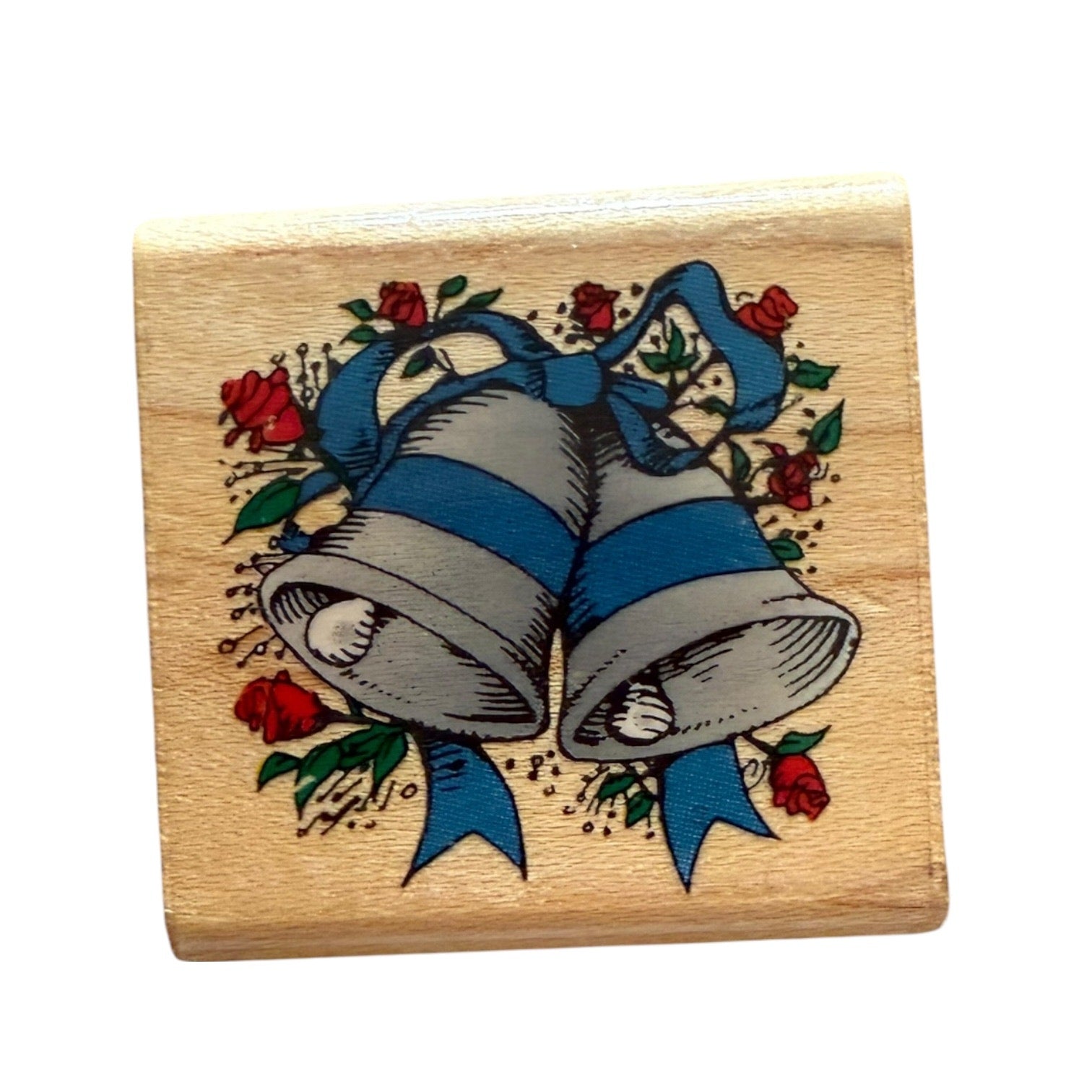 Wooden stamp with bell and rose design on a white background