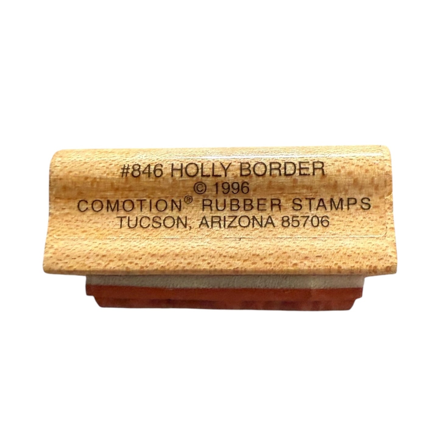Rubber stamp with wooden block and text on a white background
