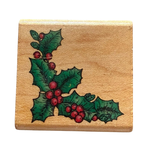 Wooden stamp with holly design on a beige background