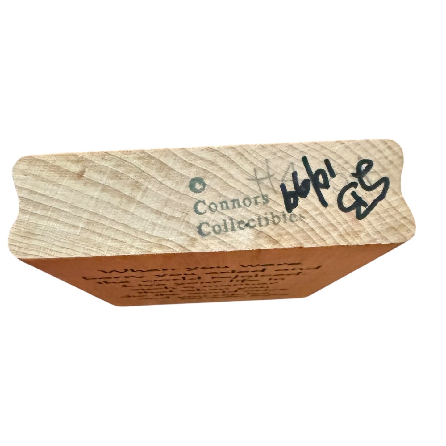 Wooden block with text and branding on a white background