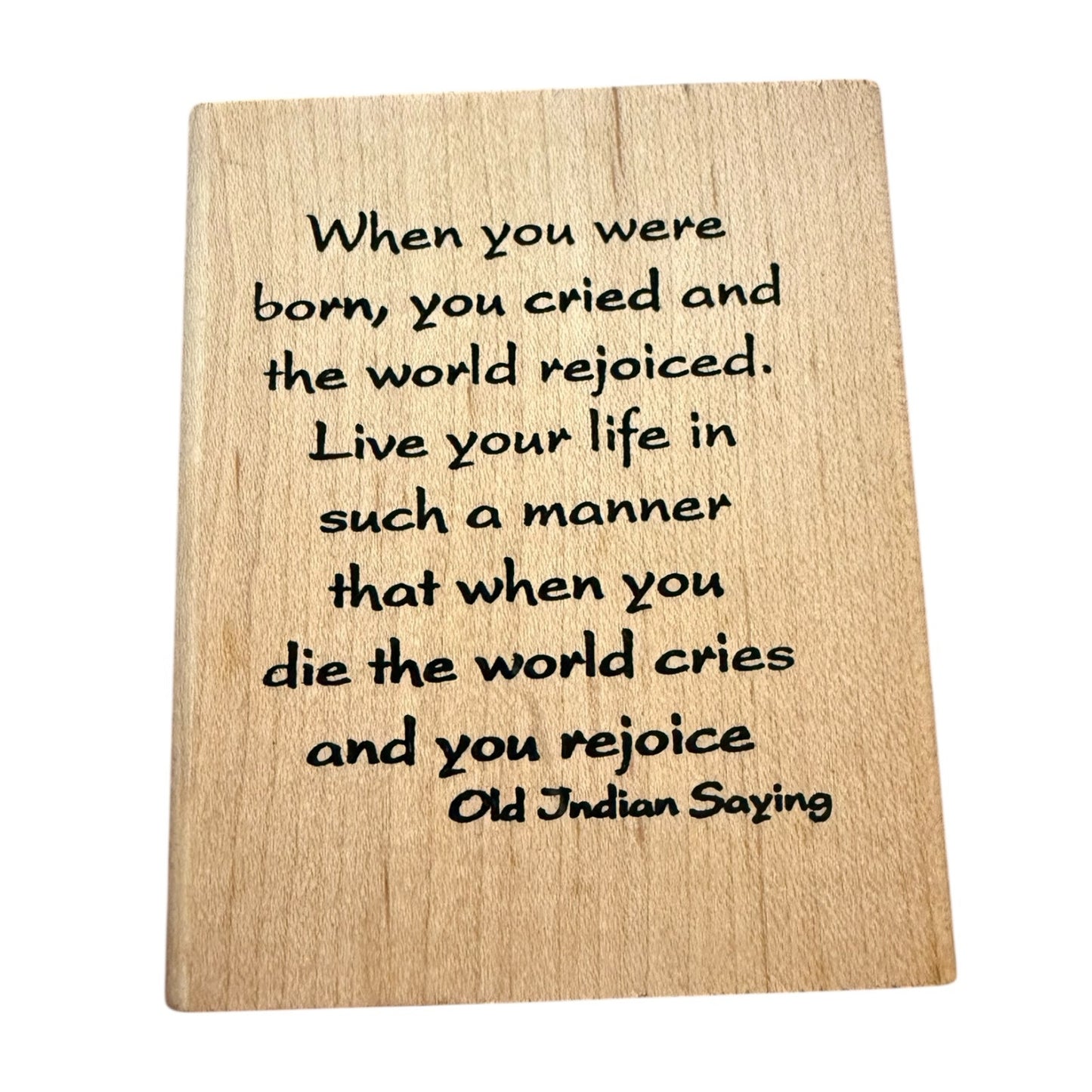 Wooden block with engraved text on a white background