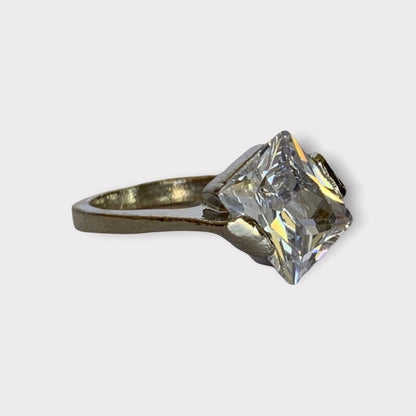 Faux Diamond ring from side on a light gray background