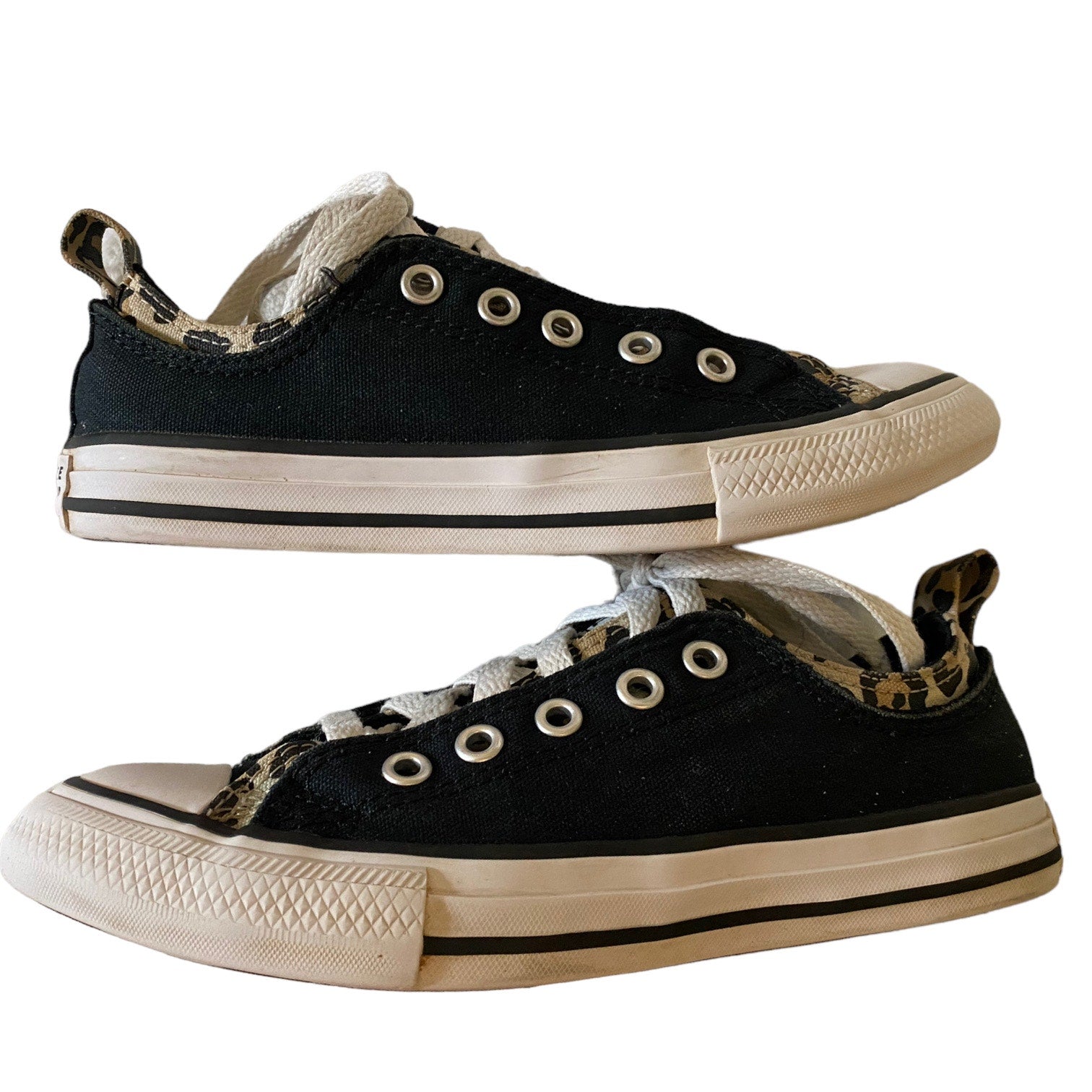 Black sneakers with white soles on a white background