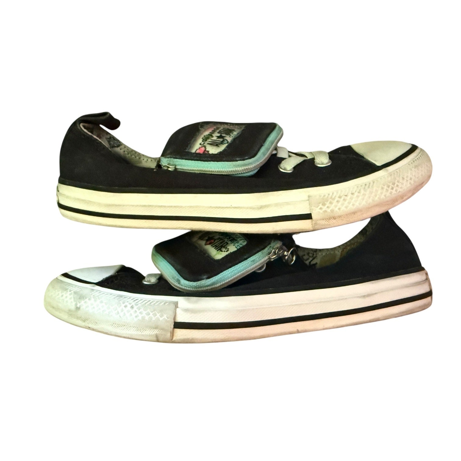 side of black Converse sneakers on a white back ground