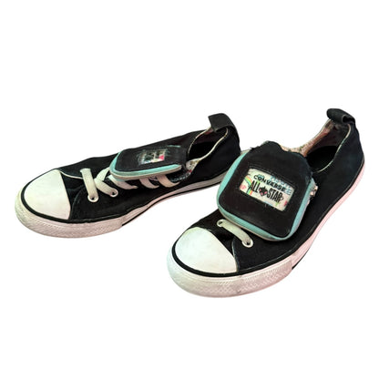 Front side of black Converse sneakers on a white back ground
