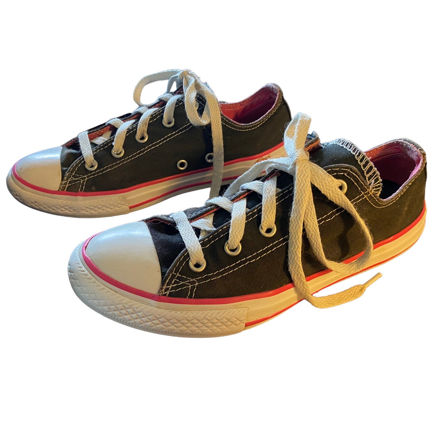 Front side Pair of black sneakers with white laces on a white background