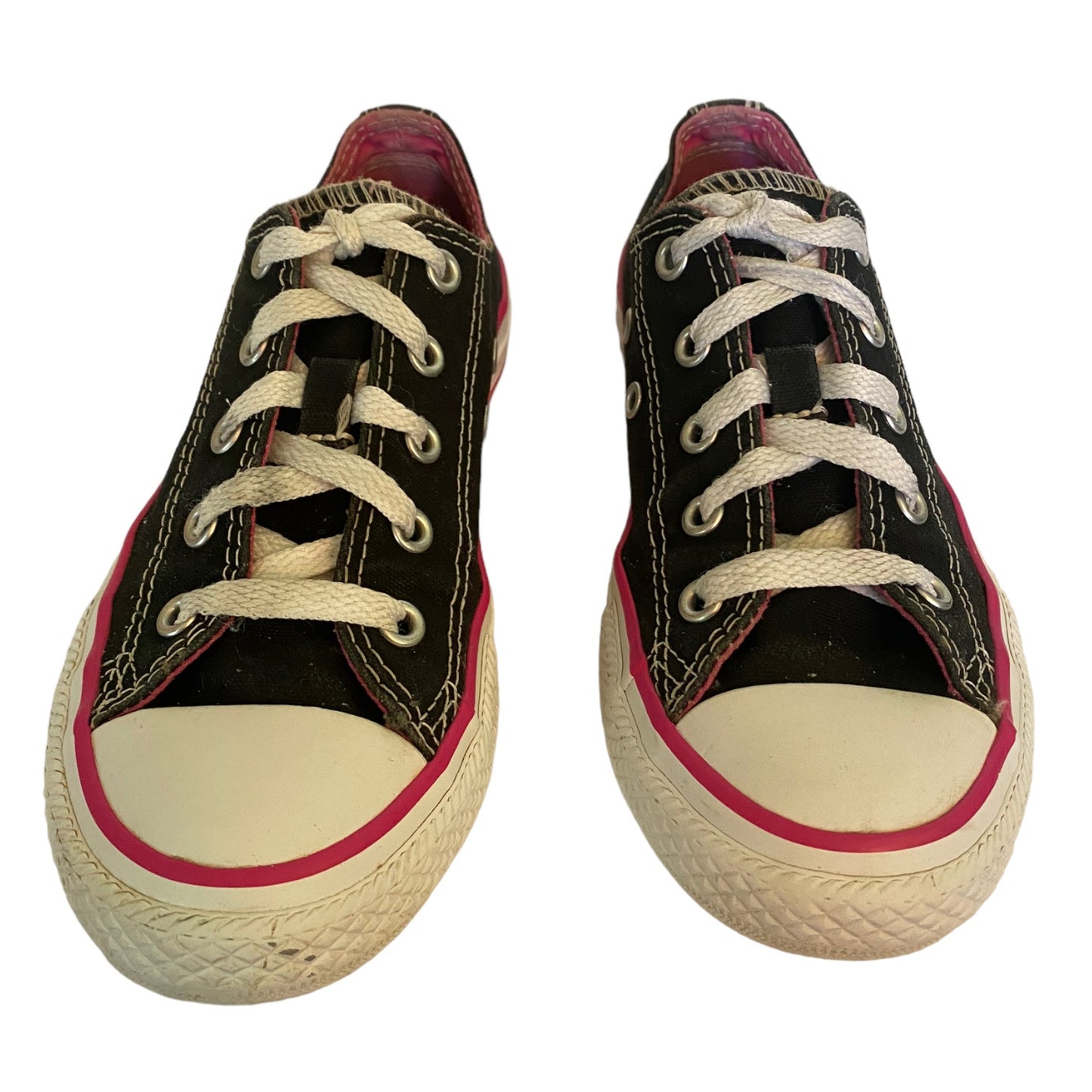 Black low top sneakers with white and pink trim on a white background
