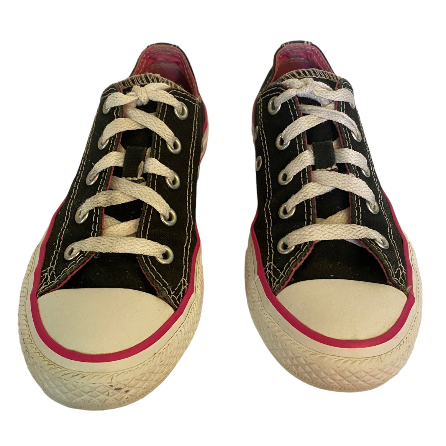 Black low top sneakers with white and pink trim on a white background