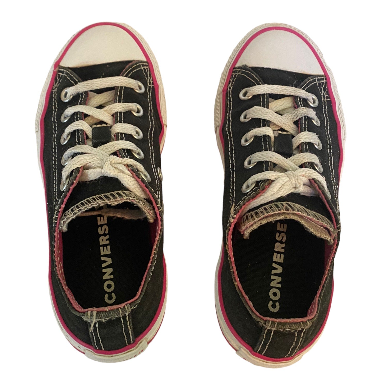 Top view of black with pink and white trim converse sneakers on a white background