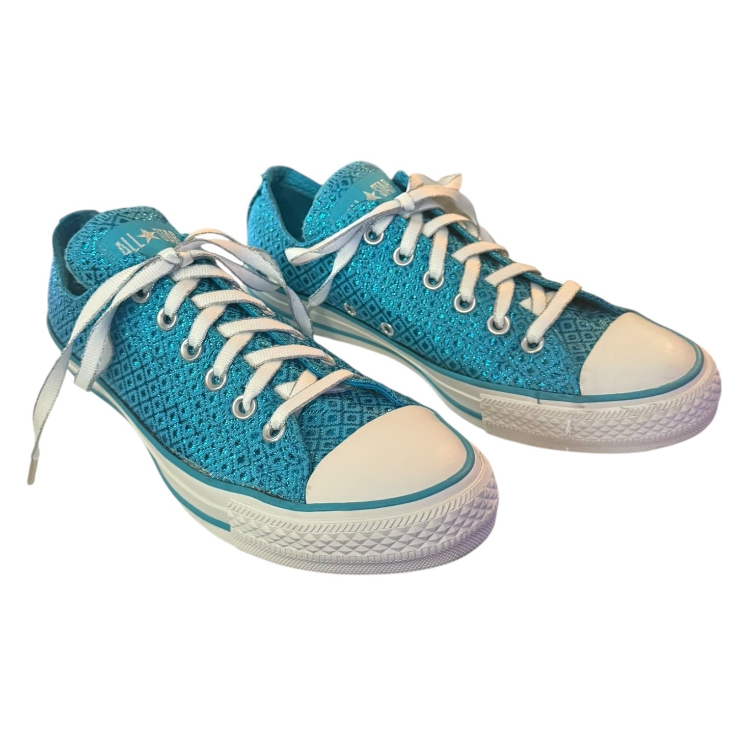 Front side of pair of blue sneakers with white laces and soles on a white background