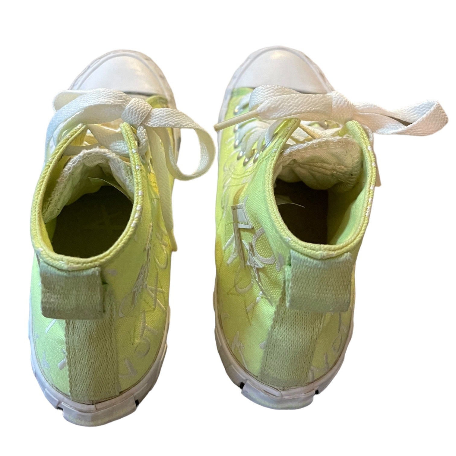 Pair of  green sneakers with white laces on a white background