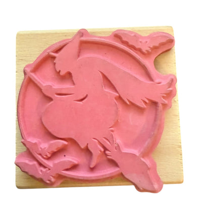 Pink witch rubber stamp on a wooden block