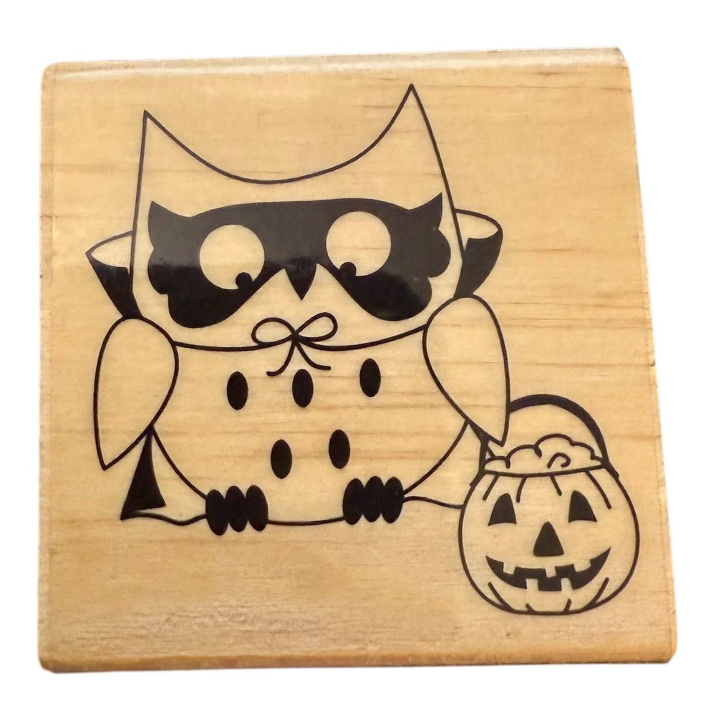 Wooden stamp with a Halloween-themed owl design on a white background