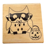Wooden stamp with a Halloween-themed owl design on a white background