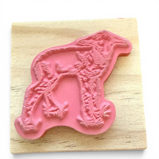 Pink lamb shaped stamp on a wooden block