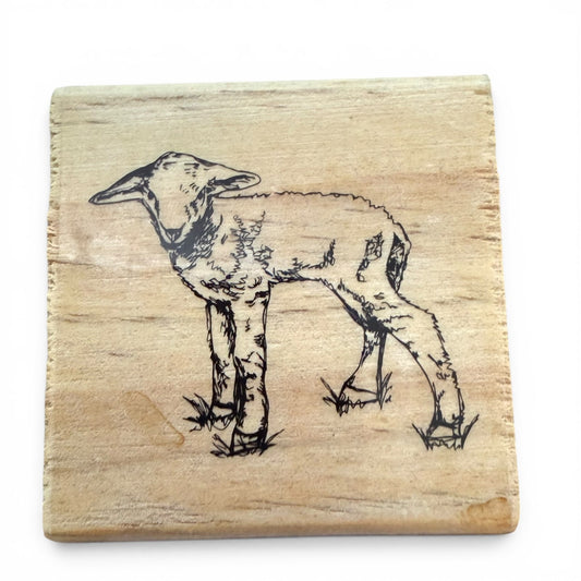 Wooden stamp with a engraved image of a lamb on a white background