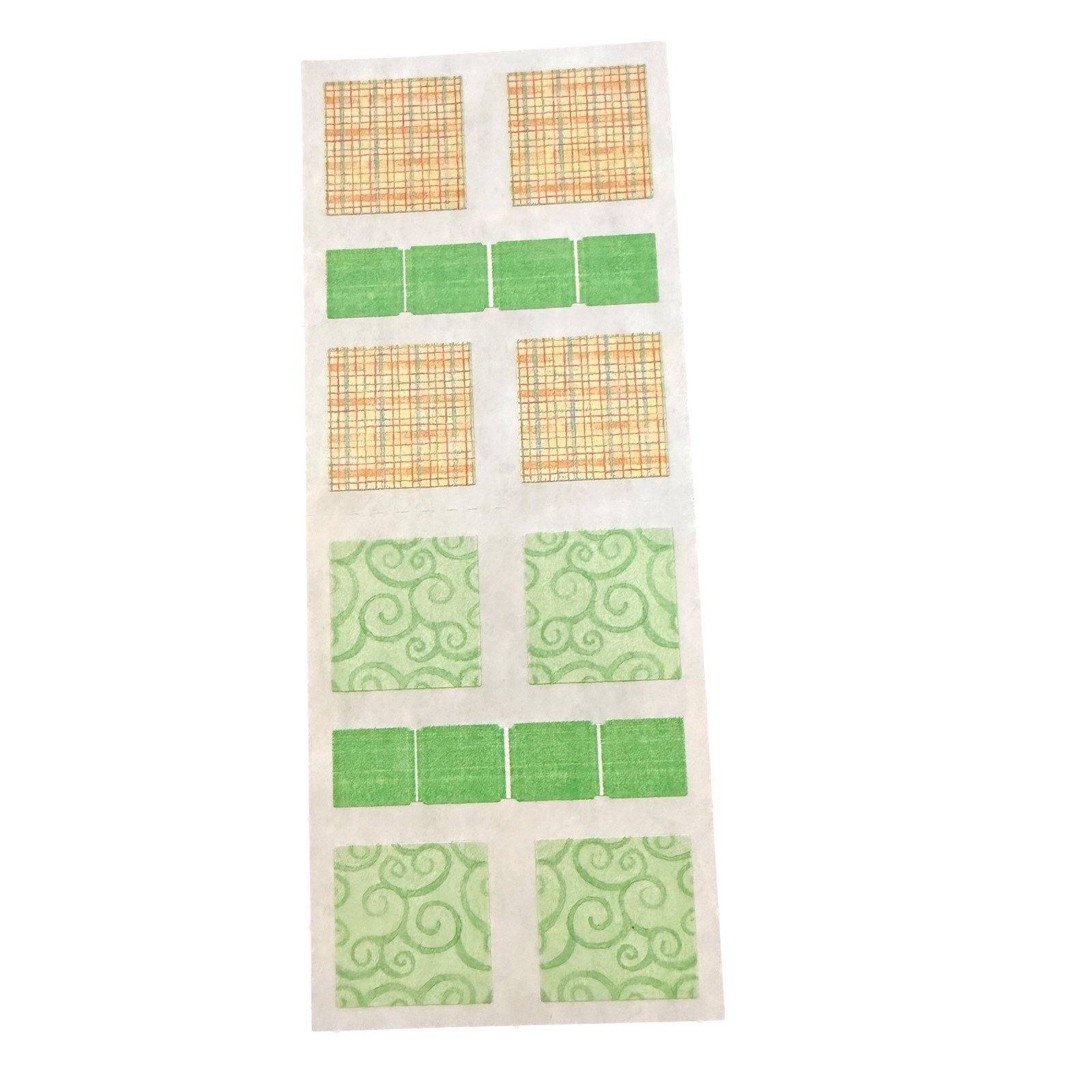 A sheet of patterned stickers arranged in a grid, featuring plaid squares, solid green squares, and green swirl patterned squares on a white backing.