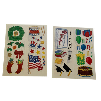 Two sheets of patriotic-themed and celebration stickers on a white background, featuring red, white, and blue designs including an American flag, stockings, wreath, stars, hats, books, graduation caps, balloons, gifts, and a cake.