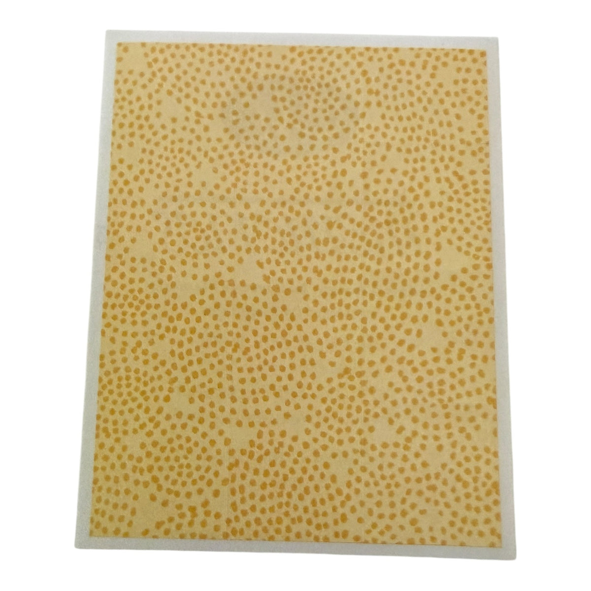 Yellow patterned sticker with a white border on a white background