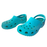 Front side of Pair of turquoise clogs on a white background