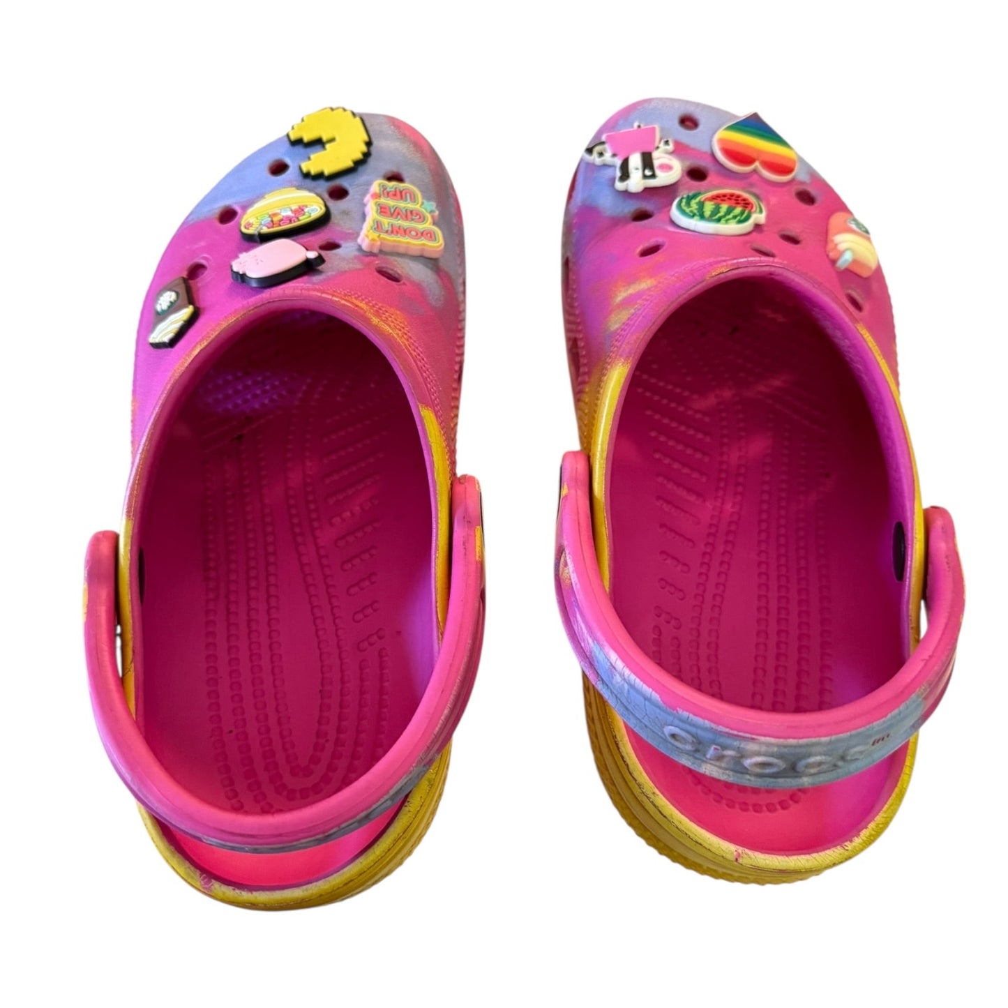 Top of colorful children's clogs with cartoon character stickers on a white background