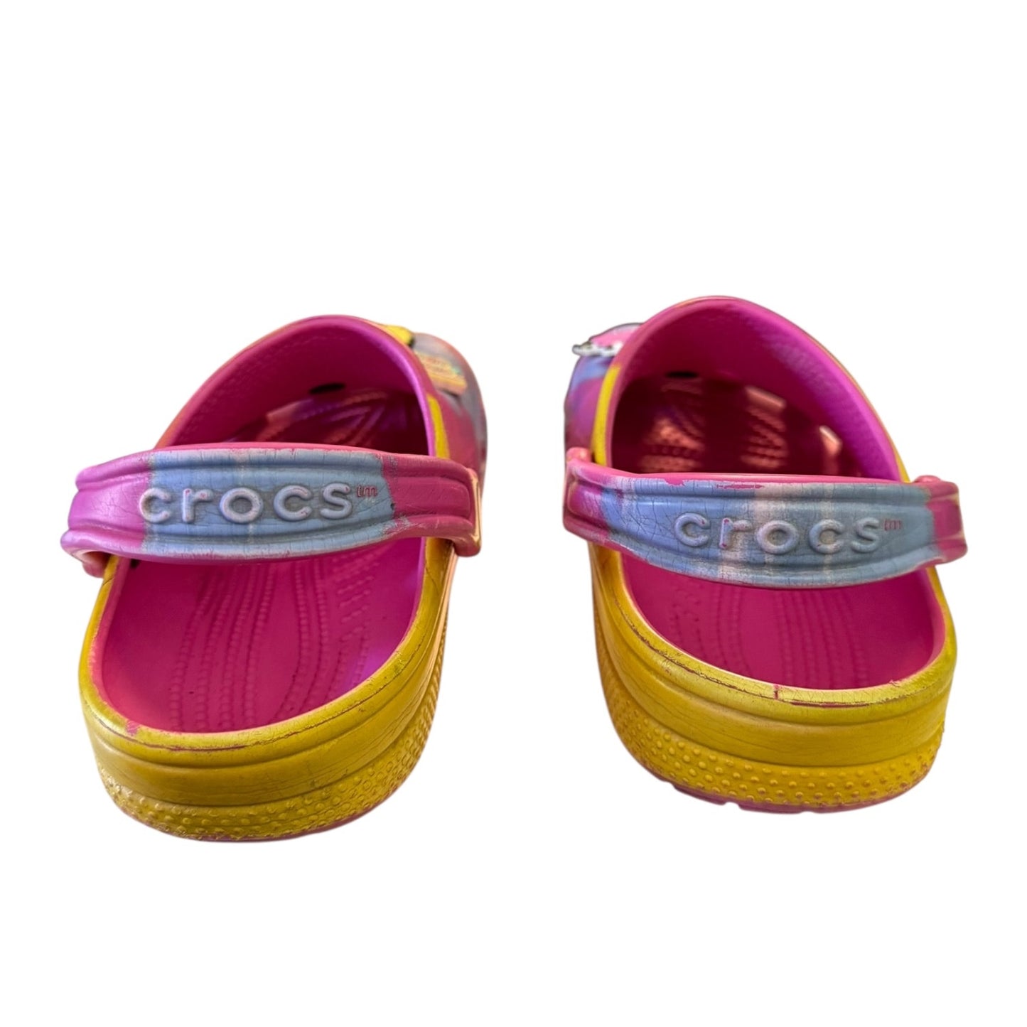 Back of Pair of pink and yellow Crocs clogs on a white background