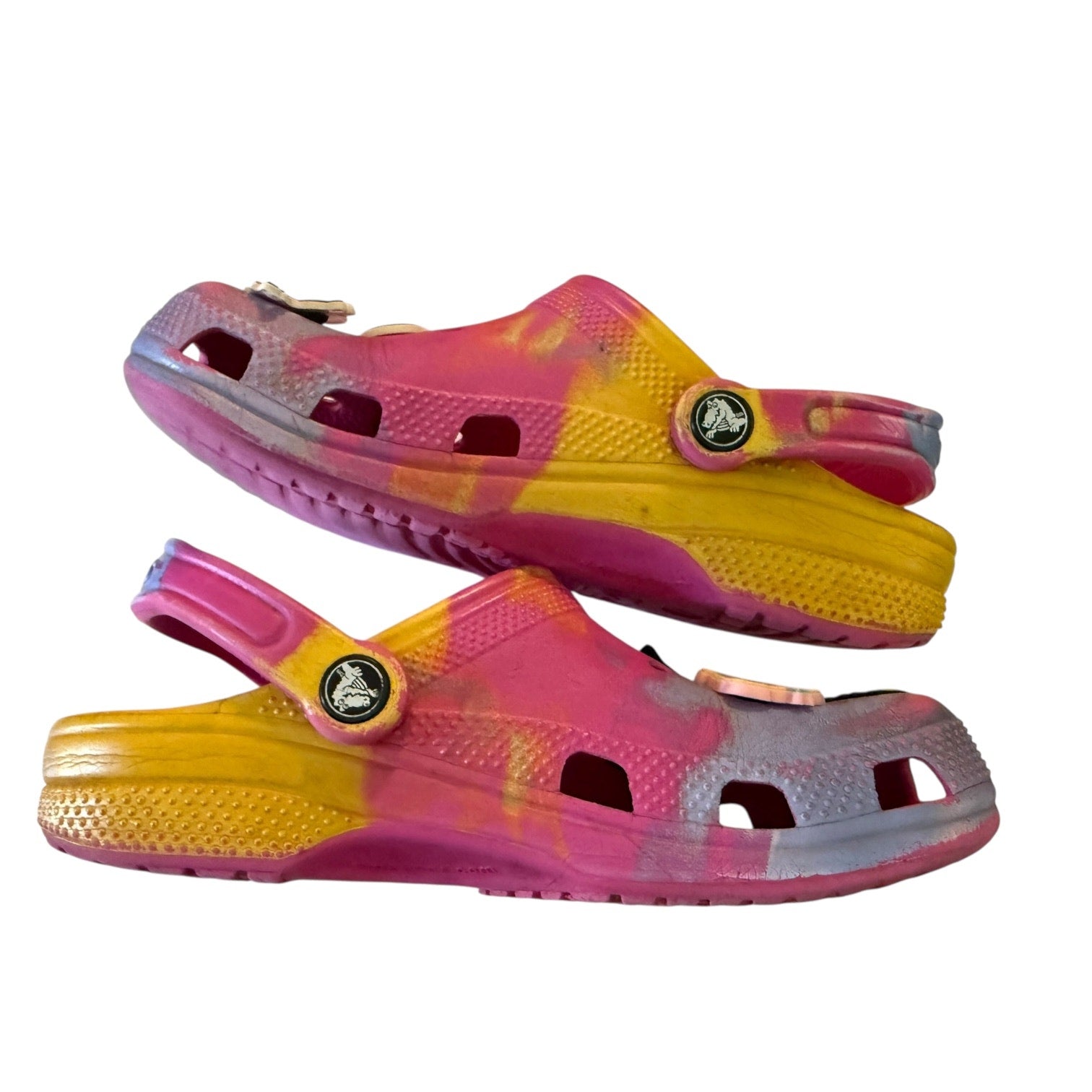 Side of Pair of pink and yellow clogs on a white background