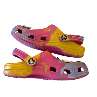 Side of Pair of pink and yellow clogs on a white background